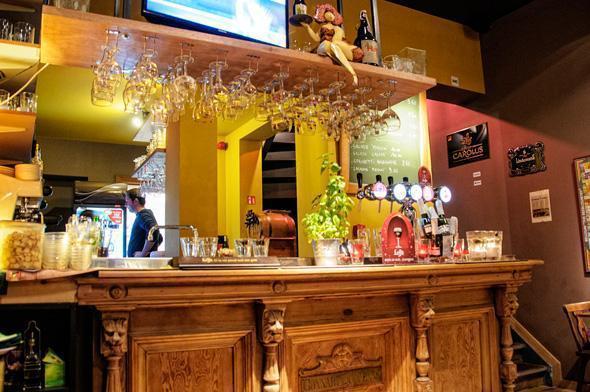 The beautiful carved wooden bar is home to more than 50 Belgian beer.