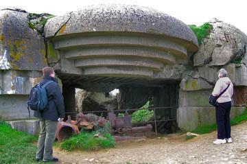 A bombed out German bunker from WWII still overlooks the beach.
