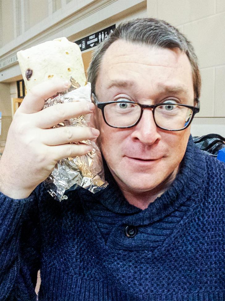 The burrito from Toro Taco is almost as big as Andrew's head.