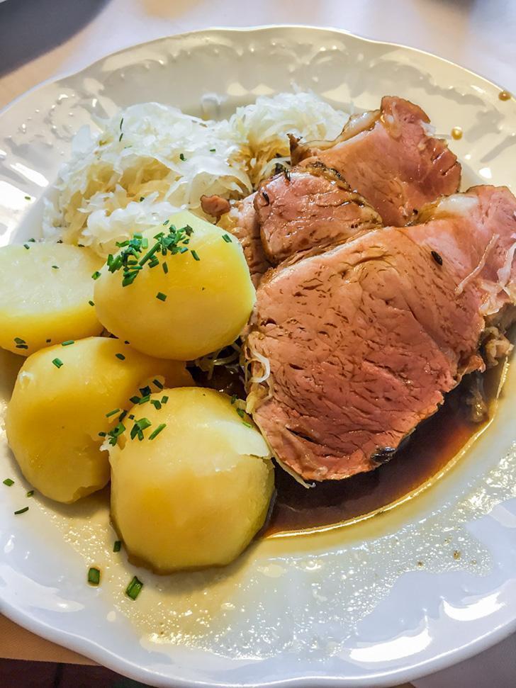 Smoked pork dinner at Gasthof Weisses Lamm restaurant in Hallstatt, Austria