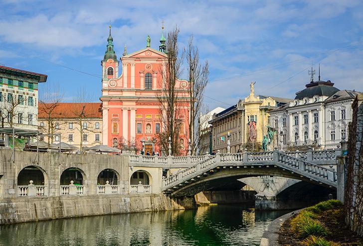 Ljubljana's Triple Bridge with the Franciscan Church of the Annunciation in the background. 